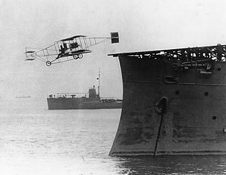 Pilot Eugene Ely takes off from USS Birmingham, Hampton Roads, Virginia, 14 November 1910 First airplane takeoff from a warship.jpg