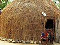 Fulani boys sitting at their hut