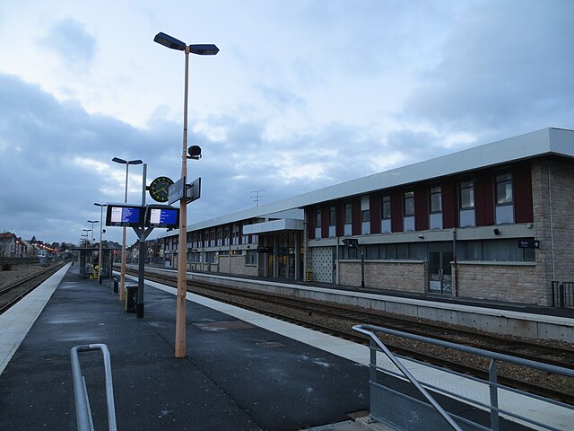 A photograph of an outdoor train platform, the sky above is grey. No trains are visible