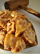 Peanut brittle cracked on a serving dish