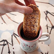 Dipping a Finnish cinnamon and sugar flavored korppu
in coffee Kanelisokerikorppu.jpg