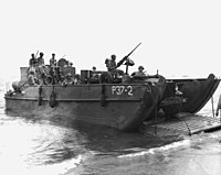Ramp down, this LCM(2) prepares to disembark a Dodge command reconnaissance truck during the Guadalcanal campaign. LCM-2 from USS President Jackson (AP-37) beached on Guadalcanal, circa 1942 (USMC 51371).jpg