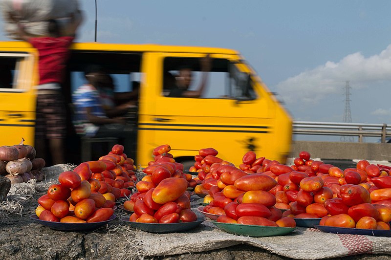 File:Lagos yellow bus with red tomatoes and blue sky.jpg