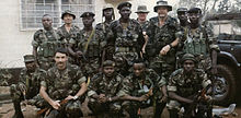 Robert C. MacKenzie (standing, wings on hat) with some of the Sierra Leone Commando Unit he was training with the Gurkha Security Guards MacKenzieSlcu.jpg