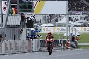 Marc Marquez, doing a wheelie to celebrate winning the MotoGP race. Marc Marquez 2018 Sepang 3.jpg