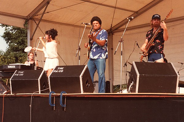 Muldaur (left) with her band on stage at the 1983 Cambridge Folk Festival, England
