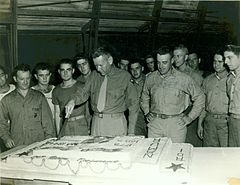 Austin R. Brunelli cutting the cake with the members of the 24th Marine Regiment during the celebration of the Marine Corps Birthday in Maui, 1944.