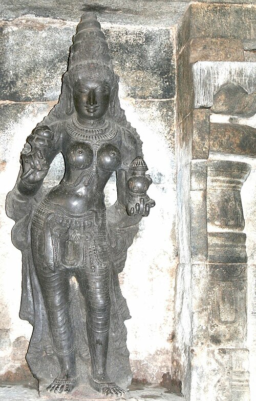 Mohini, the female form of Vishnu, holding the pot of amrita, which she distributes amongst all the devas, leaving the asuras without it. Darasuram, T