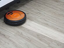 A robotic vacuum cleaner mopping Mopping vacuum cleaner robotic.jpg