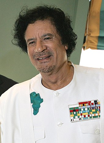 Gaddafi wearing an insignia showing the image of the African continent