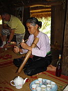 A pipe-smoking woman with cigarette plow