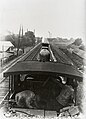 Gezicht op de spoorbaan en op de machinistencabine met stoker en machinist vanaf de tender. (1910 - 1913)