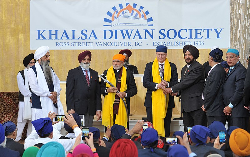 File:Narendra Modi and the Prime Minister of Canada, Mr. Stephen Harper being presented Siropa (Robe of Honour) and Sword at the Gurudwara Khalsa Diwan, at Ross Street, Vancouver, in Canada on April 16, 2015.jpg