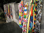 A Tōshō-gū shrine in Tokyo, Japan, on which paper cranes have been hung. The shrine also shows a dove in flight