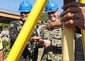 Philippine army Col. Arnulfo R. Pajarillo, left, and U.S. Navy Capt. Rodney Moore, the commanders of Joint Civil Military Operations Task Force, prepare to bury a time capsule during a groundbreaking ceremony 130319-N-VN372-020.jpg
