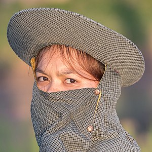 Portrait of a young woman wearing a gray balaclava