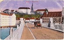 Kranj na razglednici z začetka 20. stol.: spredaj most čez Savo (današnja Ljubljanska cesta), zgoraj izstopata grad Kieselstein in Cerkev svetega Kancijana