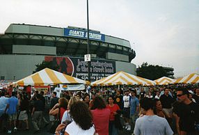 The festive park scene in the Giants Stadium parking lot for banner-celebrated, 10-night stand of The Rising Tour during July 2003. RisingTourGiantsStadiumLot.jpg