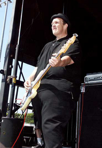 Steve Soto on stage with Adolescents at The Warped Tour
