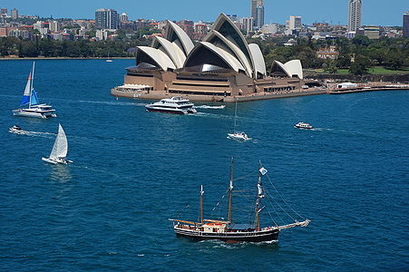 Sydney Opera House with a number of boats in foreground, most prominently a Tall Ship, but also a wide range of others.