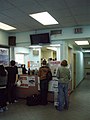 Ticket counter. The hallway to the right leads to the two washrooms as well as an employee entrance straight ahead, on the North end of the building. Lockers and Bell Canada payphones are to the right of this view.