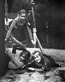 Grand Duchesses Tatiana, standing, Maria, and Anastasia play on a swing during a summer cruise in Finland in 1908