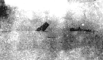 USS Reid sinking, December 11, 1944. An infantry landing craft is visible on the right. USS Reid (DD-369) sinking on 11 December 1944.jpg