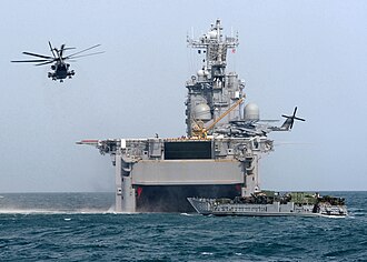 Marines from the 15th Marine Expeditionary Unit depart USS Tarawa (LHA-1), using both a Landing Craft Utility and CH-53E "Super Stallion" helicopters, during amphibious operations in Kuwait, 2003. USS Tarawa operations.jpg