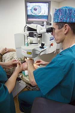 US Navy 070501-N-5319A-007 Capt. Joseph Pasternak, an ophthalmology surgeon at National Naval Medical Center Bethesda, lines up the laser on Marine Corps Lt. Col. Lawrence Ryder's eye before beginning LASIK IntraLase surgery.jpg