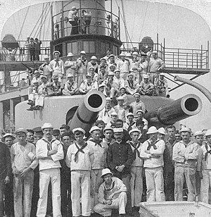 USS Iowa -- Crewmen pose by the ship's forward 12"/35 gun turret, 1898