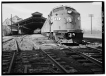 An Amtrak train under the Union Station Train Shed, 1974. VIEW LOOKING WEST, SHOWING LOCOMOTIVE AND TRAINSHED - Louisville and Nashville Railroad, Union Station Train Shed, Water Street, opposite Lee Street, Montgomery, Montgomery County, AL HAER ALA,51-MONG,23A-14.tif