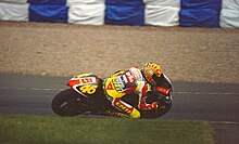 Valentino Rossi, riding his Aprilia during the 250cc race, which went on to win. Valentino Rossi 1999 Donington Park.jpg