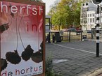 View over the bridge Hortusbrug close to the Botanical garden with a billboard on the brick sidewalk in Amsterdam; free photo by Fons Heijnsbroek, Autumn 2008