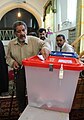 A man in Sarakhs put his vote to ballot, Iranian presidential election, 2013