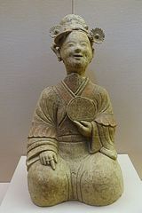 A Chinese ceramic statue of a woman holding a bronze mirror, Eastern Han period (25-220 AD), Sichuan Provincial Museum, Chengdu