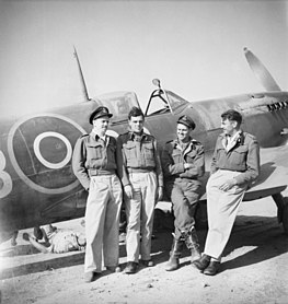 May 1944, Poretta, Corsica. In front of a Spitfire undergoing servicing are pilots (left to right) F/O W. W. Thomas of Malvern, SA; F/O E. C. House DFM DFC of Gnowangerup, WA; S/Ldr E. E. Kirkham of Concord, NSW, and; F/O H. J. Bray of Moolcolah, Qld, not long after claiming four FW190s over Italy. 451 Squadron RAAF pilots May 1944.jpg