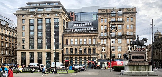 In George Square, the McLaren warehouse (1922) and Olympic House (1903) frame an earlier office by James Burnett.