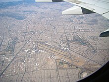 The neighborhood (center-left), next to the city's airport, as seen from an airplane. Aerial View of Mexico City Airport on 3.21.11.jpg