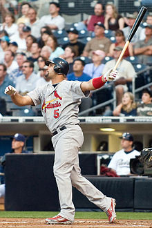 Pujols holding up a bat after a swing