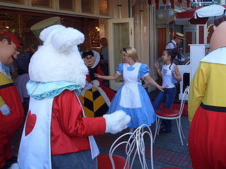 Alice and characters from her movie host "Disneyland Musical Chairs" at Coca-Cola Refreshment Corner, accompanied by a ragtime pianist. Alice plays musical chairs.jpg