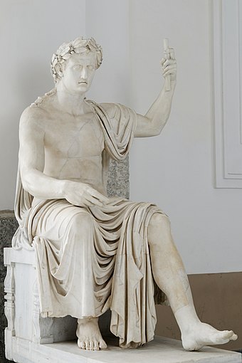 A colossal statue of Augustus from the Augusteum of Herculaneum, seated and wearing a laurel wreath.