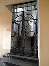 Ornamental grille in front of the staircase in the passage