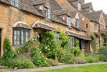 Tourists appreciate the quaint residential properties made of Cotswold stone (oolitic Jurassic limestone) Broadway row houses b 8302.jpg