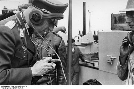 A Luftwaffe officer using a radio kit on a Panzer III, 1940