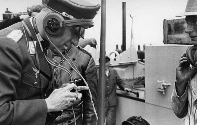 A Luftwaffe officer using a radio kit on a Panzer III, 1940