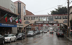 Tourist shops and historical remnants of the sardine industry line both sides of Cannery Row, which is busy even though it is raining