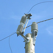 Cutout (left) attached to a feeder line (connection at the right not shown). The lower wire goes to the transformer Cutout fuse.jpg