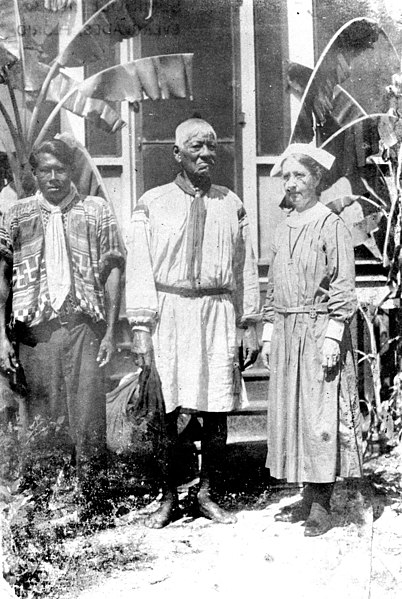 File:Deaconess Bedell with medicine man and Bobby Jim Tiger outside the mission.jpg