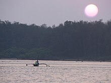 Fishermen returning home at sunset, Devbagh, Karwar Devbagh.jpg