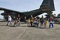 Displaced residents exit a Philippine Air Force KC-130J Super Hercules aircraft at Villamor Air Base, Philippines, after being evacuated Nov. 14, 2013, during Operation Damayan 131114-M-DG262-200.jpg